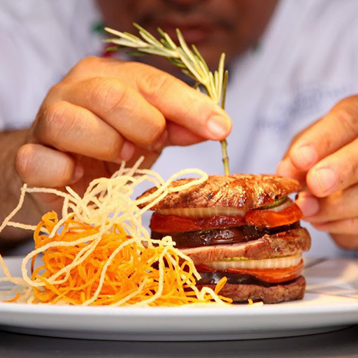 The chef adds the finishing touch to a dish